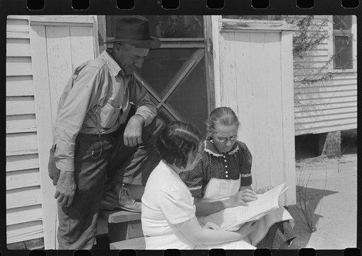 Mr. and Mrs. Watkins, FSA (Farm Security Administration) borrowers, discussing record book with project home economist, Coffee County, Alabama