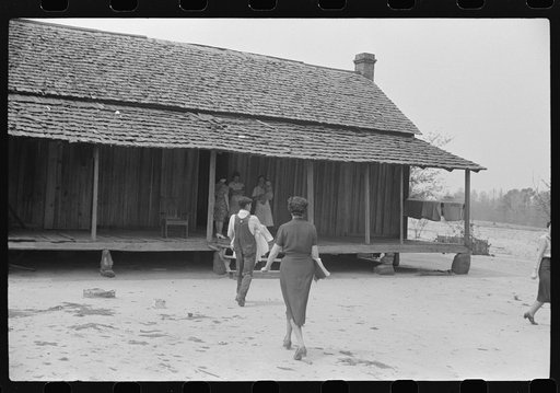 Miss Hesterly, FSA (Farm Security Administration) home economist, following Adkins family, FSA rural rehabilitation clients, into their house to help make out their home and farm plans. Coffee County, Alabama