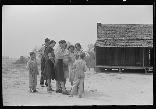 Miss Hesterley and Miss Christian, home economists discussing farm and home plan with Ellis Adkins family, rural rehabilitation borrowers, in front of their home. This is their first year on the program. There are nine in the family. Coffee County, Alabama