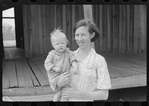 Mrs. Ellis Adkins and her youngest child. The family are rehabilitation borrowers. There are seven children and this is their first year on the program. Coffee County, Alabama