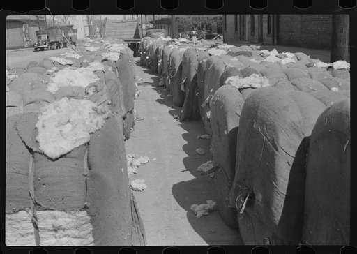 Untitled photo, possibly related to: Bales of cotton on street outside warehouse, Montgomery, Alabama