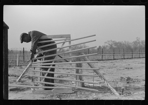 FSA (Farm Security Administration) borrower building a new gate for his yard. Prairie Farms, Montgomery, Alabama