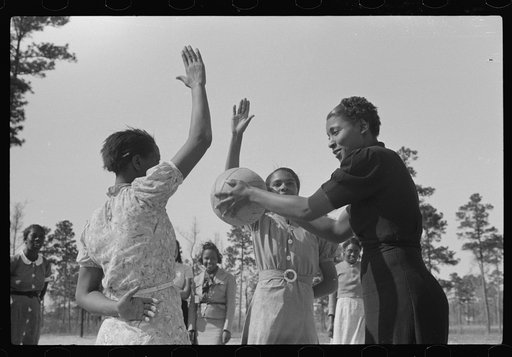 Student with recreational director during basketball game. Prairie Farms, Montgomery, Alabama