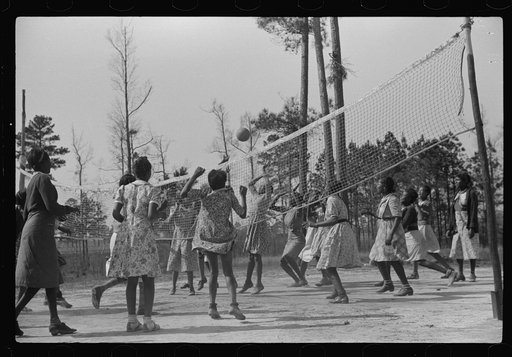 Students playing volleyball during supervised outdoor recreational period at new FSA (Farm Security Administration) project school, Prairie Farms, Montgomery, Alabama
