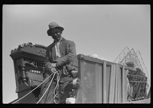 Negro day laborer moving from one man's farm to another to get work. He wasn't needed any more by former "employer." The son of his new employer said his father used to have tenants but that they "skinned" him too often by moving out on him all the time. So he just hires by the day now. Near Madison