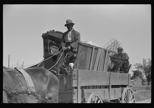 Negro day laborer moving from one man's farm to another to get work. He wasn't needed any more by former "employer." The son of his new employer said his father used to have tenants but that they "skinned" him too often by moving out on him all the time. So he just hires by the day now. Near Madison