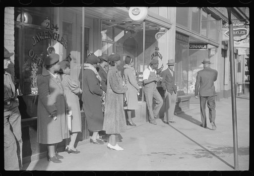 Domestic servants waiting for streetcar on way to work early in the morning. Mitchell Street, Atlanta, Georgia