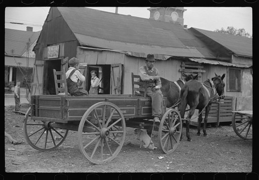 Farmer waiting for rest of his family to go home. Saturday afternoon, Enterprise, Alabama
