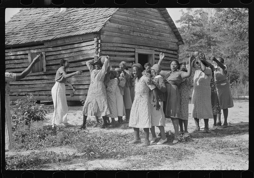Juanita Coleman helps during recreation time for adult class. In the church she teaches them to read and write and to discuss any interests and problems. Gees Bend, Alabama