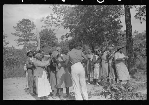 Untitled photo, possibly related to: Juanita Coleman helps during recreation time for adult class. In the church she teaches them to read and write and to discuss any interests and problems. Gees Bend, Alabama