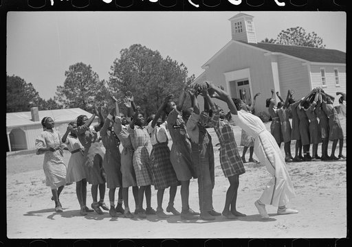 Florence Wright, recreation supervisor, starts off a game during outdoor class with schoolchildren, Gees Bend, Alabama