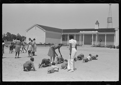 Florence Wright, recreation supervisor, starts off a game during outdoor class with schoolchildren, Gees Bend, Alabama