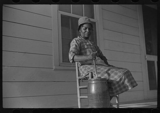 Gertrude, churning on Isaiah Pettway's porch, Gees Bend, Alabama