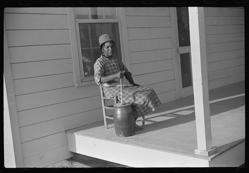 Untitled photo, possibly related to: Gertrude, churning on Isaiah Pettway's porch, Gees Bend, Alabama