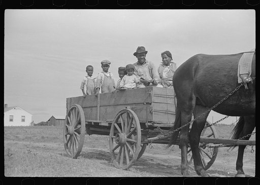 Ben Turner and family in their wagon with mule team purchased on FSA (Farm Security Administration) loan. Flint River Farms, Georgia