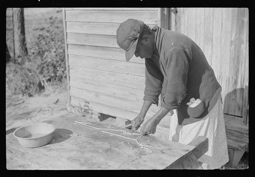 Untitled photo, possibly related to: Negro woman making "chitlins" after hog-killing. Near Maxton, North Carolina