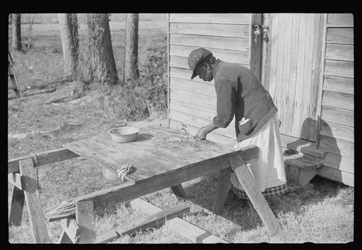Untitled photo, possibly related to: Negro woman making "chitlins" after hog-killing. Near Maxton, North Carolina