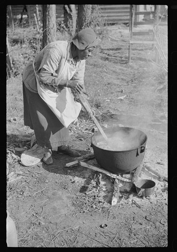 Untitled photo, possibly related to: Rendering fat after hog-killing. Near Maxton, North Carolina