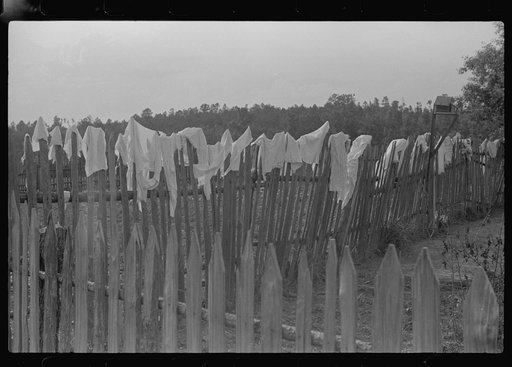 Hanging clothes on fence to dry, Greene County, Georgia