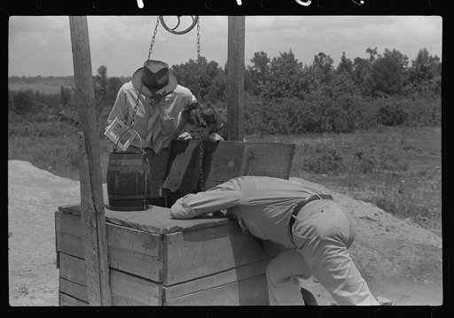 FSA (Farm Security Administration) supervisor inspecting rehabilitation borrower's well. Greene County, Georgia