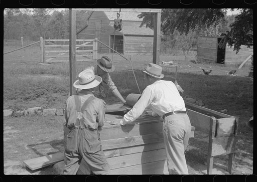 FSA (Farm Security Administration) supervisors testing rehabilitation borrower's well to tell depth of the water, Greene County, Georgia
