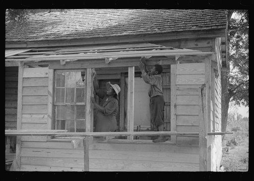 Pauline Clyburn, rehabilitation borrower, Manning, Clarendon County, South Carolina, and her son repairing home