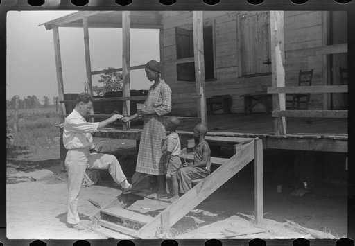 Public health doctor giving tenant family medicine for malaria, near Columbia, South Carolina