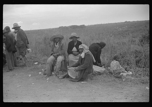 Vegetable pickers, migrants, waiting after work to be paid. Near Homestead, Florida