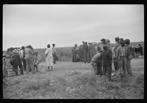 Vegetable pickers, migrants, waiting after work to be paid. Near Homestead, Florida