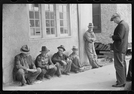 Migratory packinghouse workers waiting around post office during slack season. Belle Grande, Florida