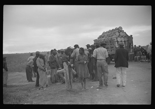 Vegetable pickers, migrants, waiting after work to be paid. Near Homestead, Florida