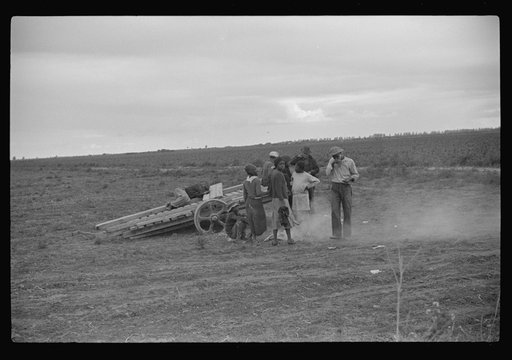 Vegetable pickers, migrants, waiting after work to be paid. Near Homestead, Florida