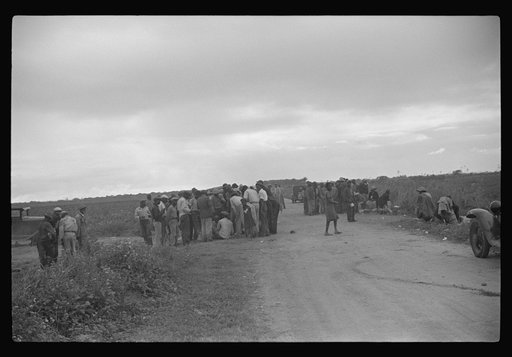 Vegetable pickers, migrants, waiting after work to be paid. Near Homestead, Florida