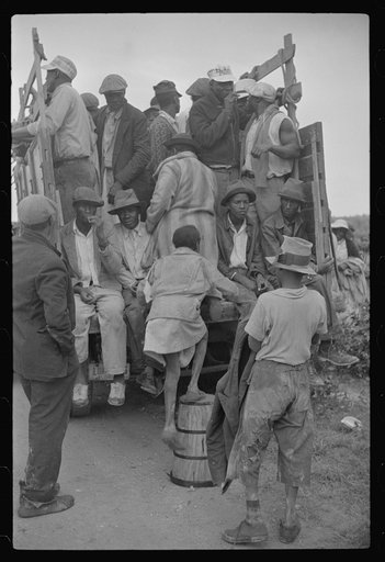 Vegetable workers, migrants, waiting after work to be paid. Near Homestead, Florida
