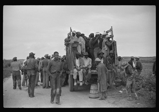 Vegetable workers, migrants, waiting after work to be paid. Near Homestead, Florida
