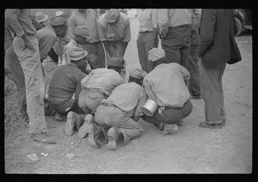 Vegetable workers, migrants, waiting after work to be paid. Near Homestead, Florida