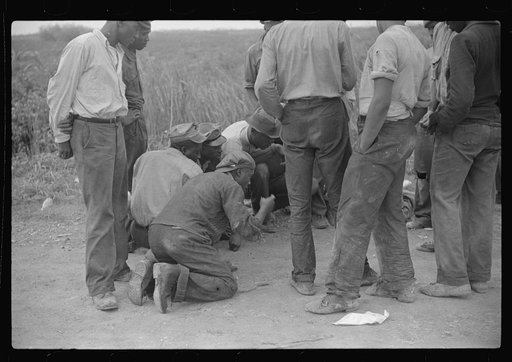 Vegetable workers, migrants, waiting after work to be paid. Near Homestead, Florida
