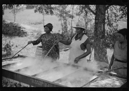 Untitled photo, possibly related to: Skimming the boiling cane juice to make sorghum syrup at cane mill near Carr, Orange County, North Carolina
