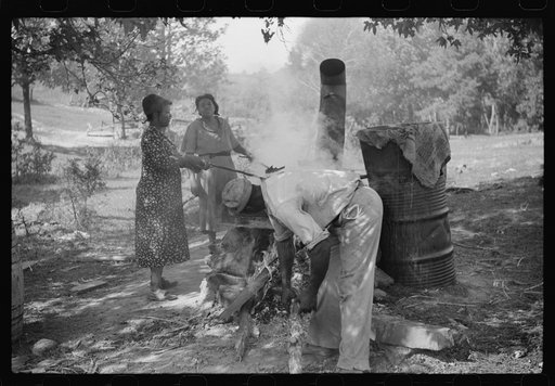 Untitled photo, possibly related to: Skimming the boiling cane juice to make sorghum syrup at cane mill near Carr, Orange County, North Carolina