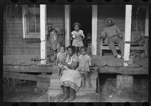 One of tenant families on their porch, Marcella Plantation, Mileston, Mississippi Delta, Mississippi
