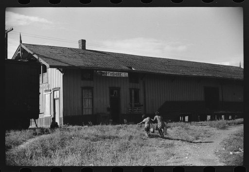 Mexican children carrying water to old railroad station where many Mexican families live during cotton picking season on Knowlton Plantation, Perthshire, Mississippi Delta, Mississippi