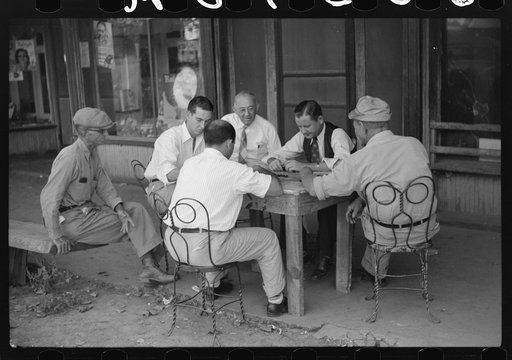 Playing dominoes or cards in front of drug store in center of town, in Mississippi Delta, Mississippi
