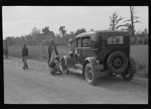 Untitled photo, possibly related to: Repairing tire on road near Knowlton Plantation, Perthshire, Mississippi Delta, Mississippi