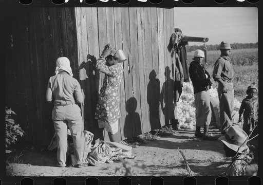 Day laborers by cotton house after picking cotton on Marcella Plantation, Mileston, Mississippi Delta, Mississippi