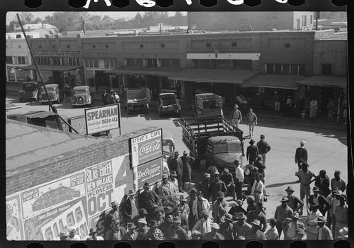 Itinerant salesman selling goods from his truck to Negroes in center of town on Saturday afternoon. Belzoni, Mississippi Delta, Mississippi