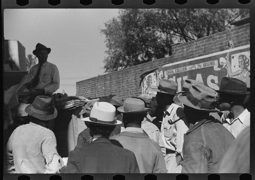 Untitled photo, possibly related to: Itinerant salesman selling goods from his truck to Negroes in center of town on Saturday afternoon. Belzoni, Mississippi Delta, Mississippi