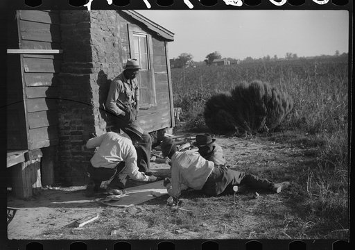 Negroes shooting craps behind a tenant house, disposing of their cotton money on Saturday afternoon, Marcella Plantation, Mileston, Mississippi Delta, Mississippi