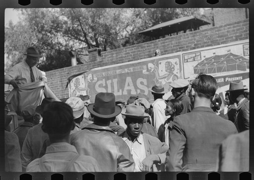 Untitled photo, possibly related to: Some of the negroes watching itinerant salesman selling goods from his truck in center of town on Saturday afternoon, Belzoni, Mississippi Delta, Mississippi