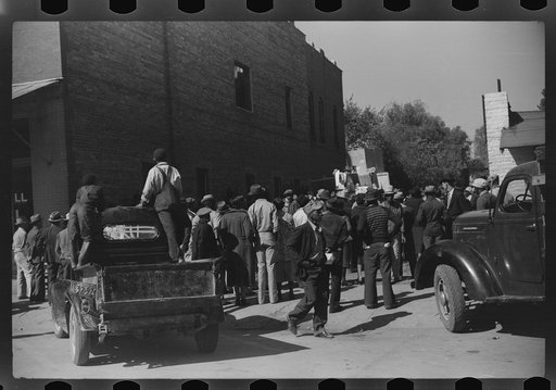 Untitled photo, possibly related to: Some of the negroes watching itinerant salesman selling goods from his truck in center of town on Saturday afternoon, Belzoni, Mississippi Delta, Mississippi