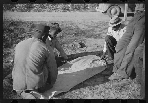 Untitled photo, possibly related to: Negroes shooting craps behind tenant house, disposing of their cotton money on Saturday afternoon, Marcella Plantation, Mileston, Mississippi Delta, Mississippi